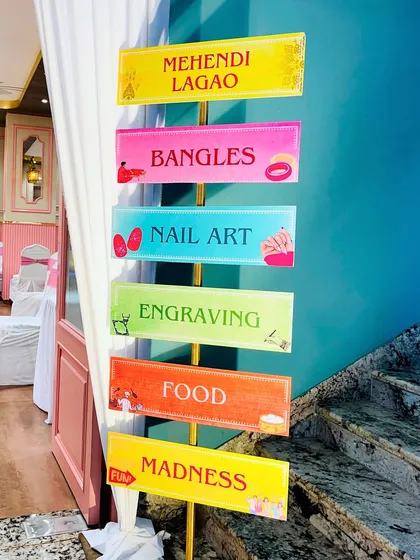 This colorful signpost perfectly captures the fun and madness of the Mehendi event, with directions for everything from henna to food.