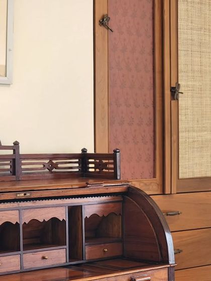 An antique writing desk paired with a custom-built wardrobe. This composition shows how I integrate cherished older pieces with new, complementary designs to create a space that feels collected and personal.