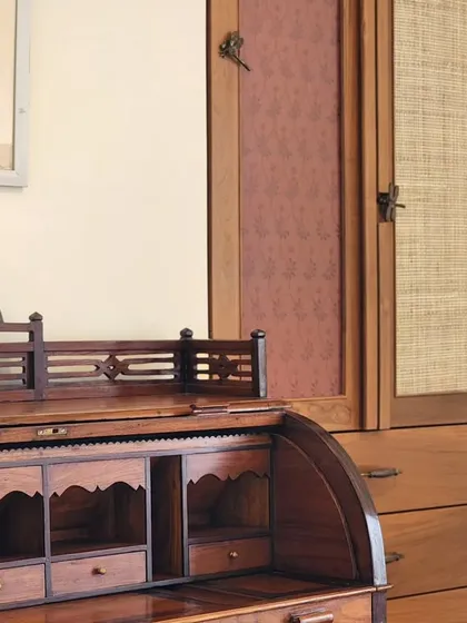 An antique roll-top desk paired with a custom-built wardrobe. We often integrate clients' existing furniture into our designs, creating a layered space that feels collected and personal over time.