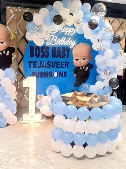 This Boss Baby first birthday for Tejasveer featured a cake table made of balloons and a large marquee number, creating a fantastic focal point.