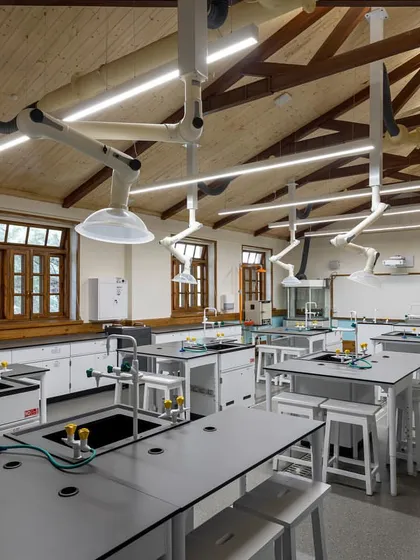A 21st-century science lab inside a 19th-century building. This project at Woodstock School demonstrates how we seamlessly integrate modern technology, like advanced ventilation and flexible lab stations, into historic architecture without compromising the building's character.
