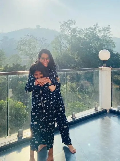 A warm hug in matching jammies. This candid shot captures the joy of twinning in our comfortable and stylish nightwear.
