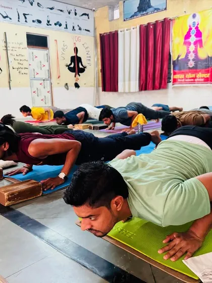 Students practice Chaturanga Dandasana, a fundamental pose for building upper body and core strength in Vinyasa yoga. We focus on correct form to prevent injury.