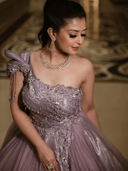 An elegant portrait in our royal lavender ball gown. This shot highlights the beautiful contrast between the soft tulle skirt and the structured, embroidered bodice.