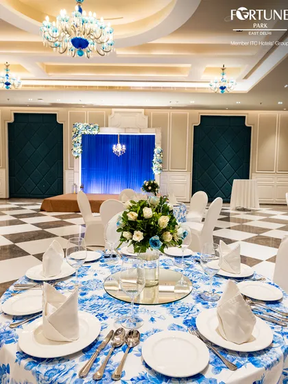 A close-up of a table setting in my banquet hall, featuring crisp linens, elegant floral arrangements, and perfectly folded napkins. I pride myself on the meticulous attention to detail that makes every celebration flawless.