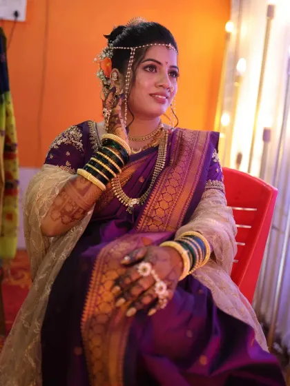 A candid moment of the bride, looking radiant and happy. The makeup is designed to be picture-perfect from every angle.