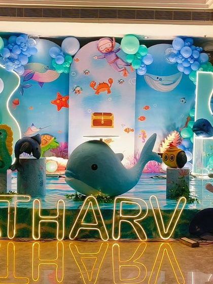 Another perspective of the underwater birthday setup, highlighting the custom neon name lighting and detailed character props.