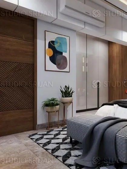 This bedroom features a mix of textures, from the geometrically patterned rug to the diagonally grooved wooden door and the glossy finish of the wardrobes.