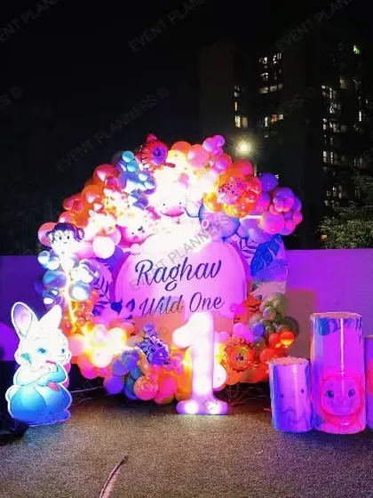 An outdoor "Wild One" first birthday party setup on a terrace.