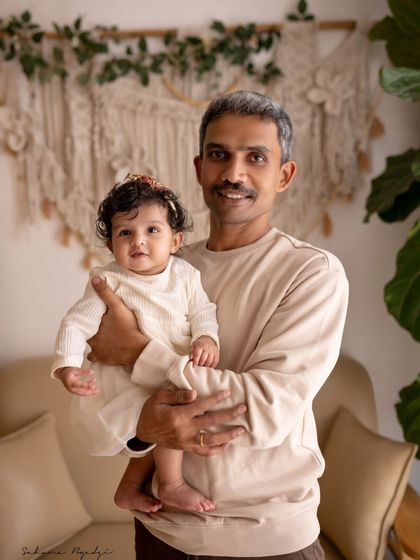 The cutest phase of life. A proud father holds his adorable baby girl in this simple and sweet portrait.