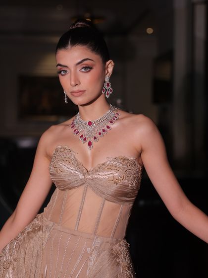 A close-up of a custom-made champagne-toned gown. The corseted bodice is intricately hand-worked, designed to mirror the modern bride who is strong yet tender, timeless yet new.