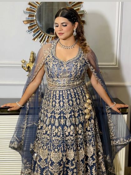 The full look for this glamorous reception. The client looks confident and beautiful in her heavily embroidered gown, with makeup and hair that complete the ensemble.