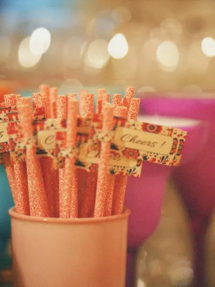 Even the straws can be part of the fun. For the cocktail party, I added these small custom flags that say "Cheers!" to the drink stirrers, adding a playful and festive touch to the bar setup.