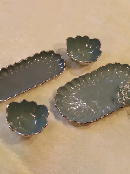 My enameled serveware in a lovely sage green. This set of platters and bowls is perfect for hosting a brunch or a casual get-together, adding a touch of modern elegance to your table.
