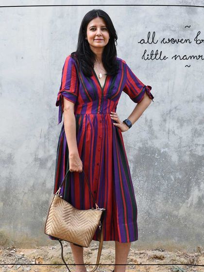 Tulika holding the All Woven Bronze Little Namrata as a grab bag, demonstrating its multiple carrying options.