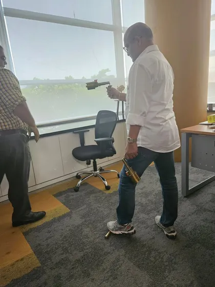 Using my energy scanner in a corporate office. This tool helps me pinpoint zones with low energy that could be impacting employee morale or business performance.