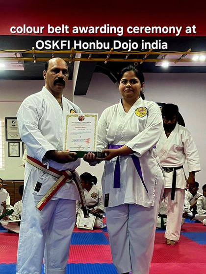 A student receives her purple belt and certificate during our colour belt awarding ceremony at the Honbu Dojo. Each belt promotion is a formal recognition of the student's progress and dedication.