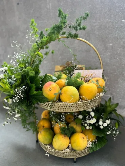 We celebrate every season in style. This decorative mango basket, filled with fresh mangoes and lush greenery, is a perfect example of our seasonal and corporate gifting solutions.