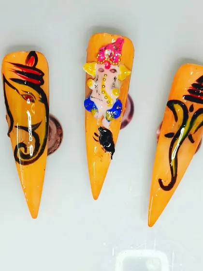 I am very proud of my custom Ganesha nail art, perfect for festivals. This set includes both detailed free-hand painting and a sculpted 3D Ganesha, showing the range of custom designs I can create for you on press-on nails.
