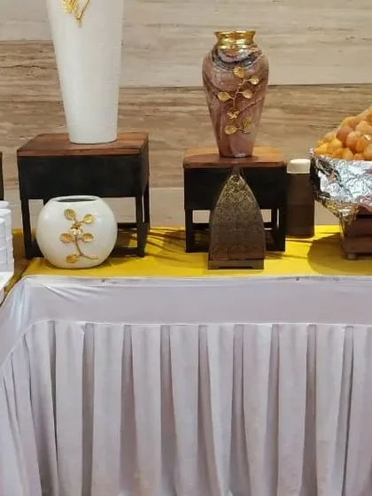 A dessert and sweets corner decorated with beautiful vases and traditional Indian serveware. I pay close attention to making every part of the buffet look appealing.