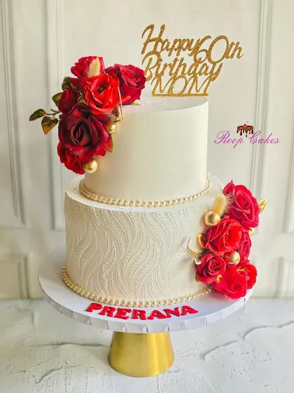 A cake to celebrate a milestone as special as a 60th birthday for a mom. This two-tier design combines classic elegance with bold red roses and delicate pearl borders, creating a look that is both timeless and celebratory.