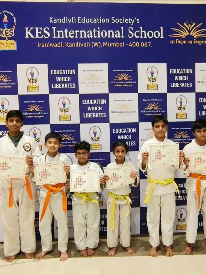 This group of boys at KES International School showcases different levels of achievement, with both yellow and orange belts. We foster a supportive environment where students encourage one another to improve.