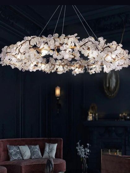 This stunning wreath-like chandelier is adorned with countless small, flower-shaped crystals. It's a breathtaking centerpiece for a dark, moody room.