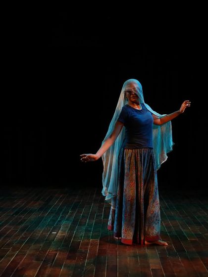 A dancer with a veil during a tech run.