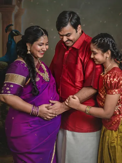 The father and daughter gently touch the baby bump, a gesture of shared anticipation and love for the new life coming.