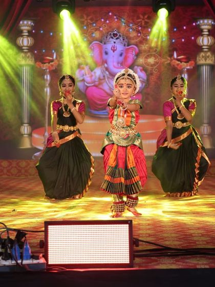 Our young performers on a brightly lit stage, their colorful costumes shining under the lights. Every performance is a celebration of art and culture.