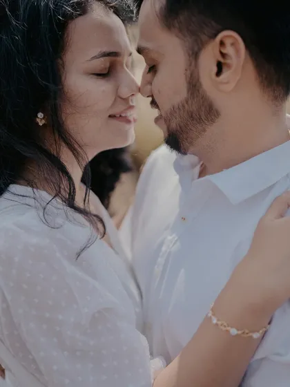 An intimate close-up that captures the couple's tender connection. The soft focus and natural light create a very romantic and dreamy feel.