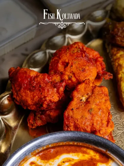 A glimpse of the Fish Koliwada from our Akbari Thaal. These crispy, spice-battered fish fritters are a taste of Mumbai's coast, served with a royal twist.