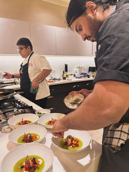 My team and I plating a vibrant tomato and strawberry gazpacho. We work together closely to ensure every dish goes out looking and tasting exceptional.