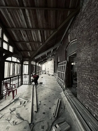 A view of a verandah under construction. This image shows the raw state of a project, with the underlying structure of brick and wood exposed before the final finishes are applied.