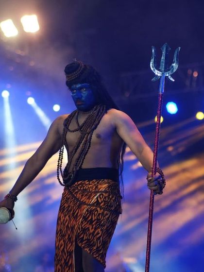 A student embodying Lord Shiva on stage at IIT Roorkee's cultural fest. The powerful pose with the trishul makes for a dramatic and memorable photograph.