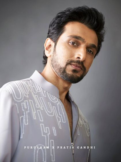 One glance, and the room is his. Pratik Gandhi, effortlessly suave and exuding charm in this modern grey kurta.