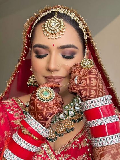 A beautiful close-up showing the details of the smokey eye makeup and the intricate henna design.