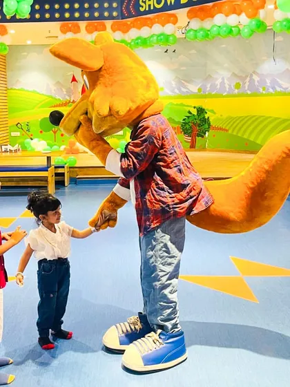 J the Fox interacts with two young children during our Independence Day celebration.