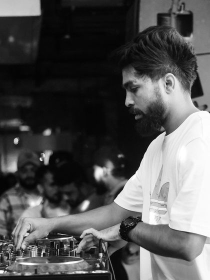 A black and white shot of me mixing at Social. It highlights the hands-on, technical skill involved in DJing.