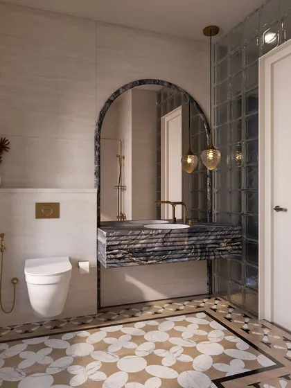 The vanity area continues the bathroom's elegant theme with a floating marble sink and an arched mirror. The patterned floor inlay adds another layer of intricate detail.