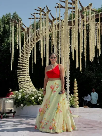 My full outfit against the stunning floral wedding decor. The red and yellow of my lehenga complemented the theme perfectly.