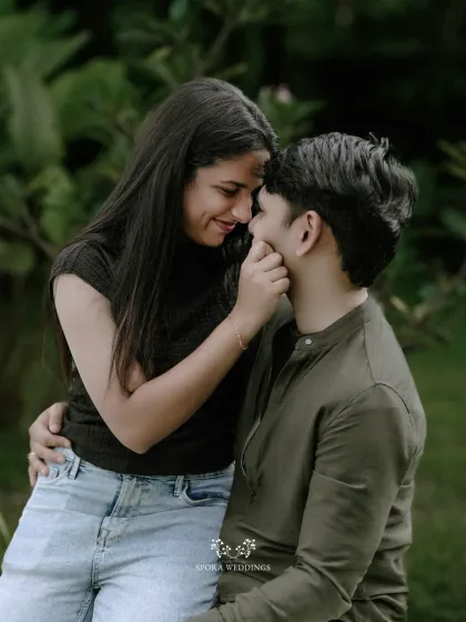 A tender moment as she gently touches his face, their expressions full of affection and warmth.