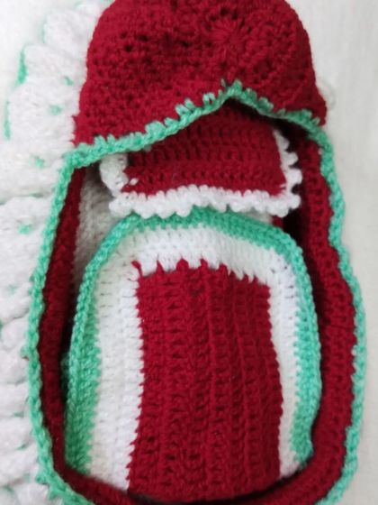 The complete travel bedding set, all packed inside the travel bed. This includes the mattress, a small pillow, and a matching blanket to keep Bal Gopal snug.