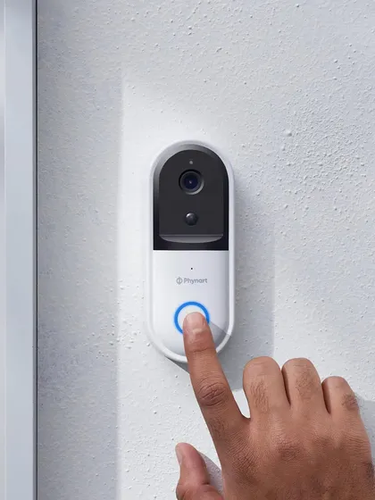 This shot shows the Phynart video doorbell in its intended environment, with a finger pressing the button. It’s a clear, utility-focused image that instantly communicates the product's function.