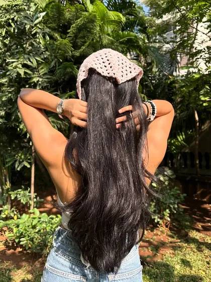 The back view of our crochet bandana, showing how it ties for a secure and adjustable fit. It works beautifully with long hair.