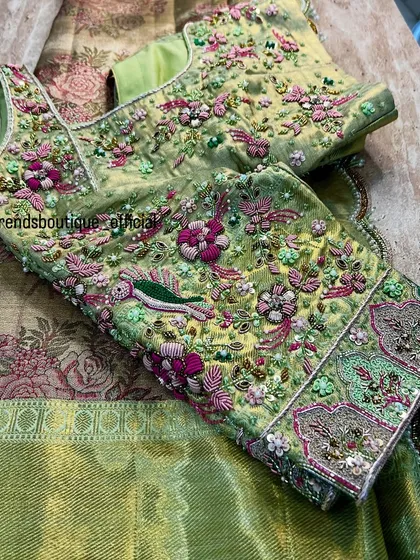 This blouse is a garden in full bloom, crafted with delicate 3D floral embroidery and beadwork. The pastel green fabric is adorned with colorful birds and flowers, creating a piece that is both royal and whimsical.