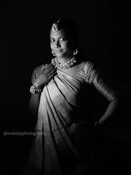A classic black and white portrait of the Haldi bride. This shot focuses on her expression and the beautiful details of her attire, creating a timeless and elegant photograph.