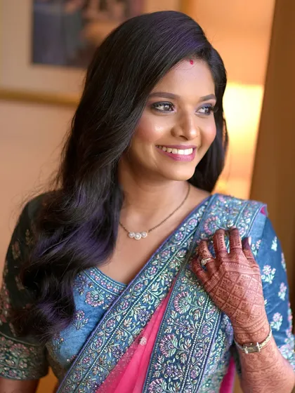 A beautiful, happy shot of the bride at her reception. The smokey eyes make her gaze captivating, while her skin remains fresh and glowing.