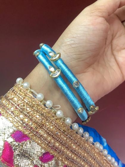 Explore my range of blue silk thread bangles, featuring different styles with kundan stones, coins, and pearl embellishments.