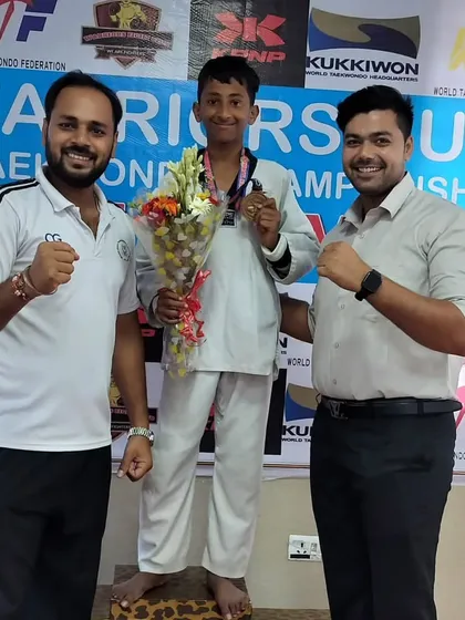 A student receiving his medal and a bouquet at the Warriors Cup. We ensure our students' achievements are celebrated.